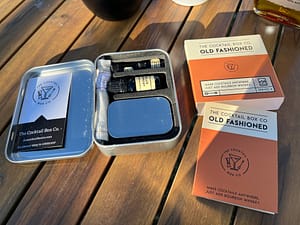 The Cocktail Box Co's Old Fashioned cocktail kit opened showing all of the included ingredients to make camping cocktails.